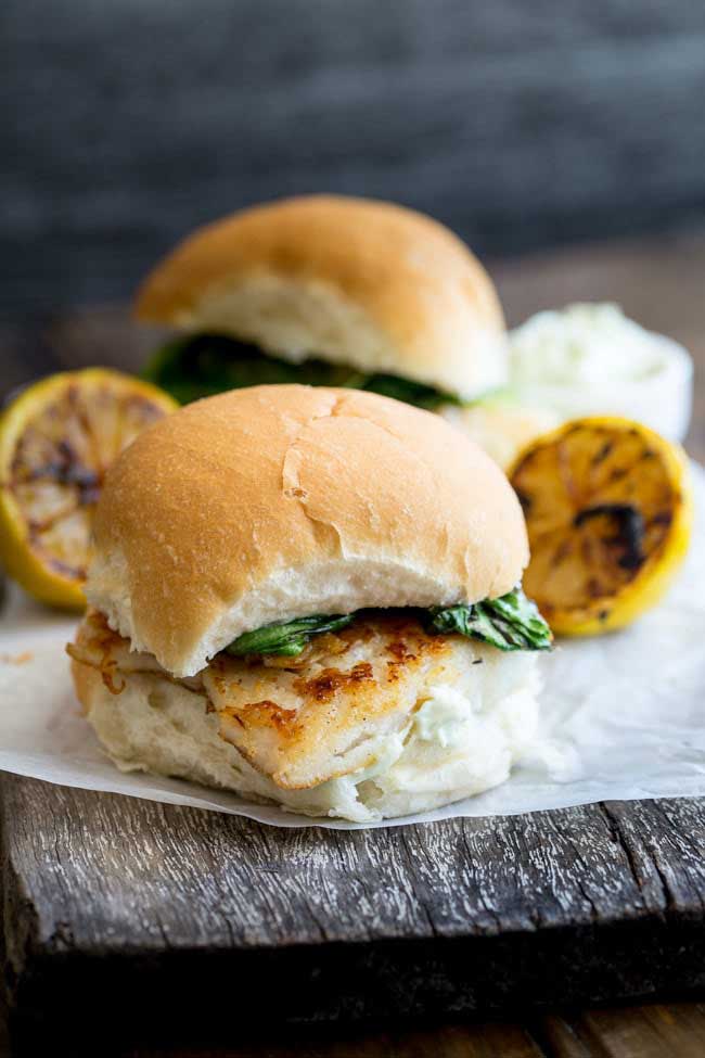 Crispy fish with a delicious tarragon mayonnaise and sweet charred lettuce, all served in a soft white bread roll. This fish burger is a flavour explosion and the perfect way to enjoy fish. And ready in under 15 minutes! From www.sprinklesandsprouts.com