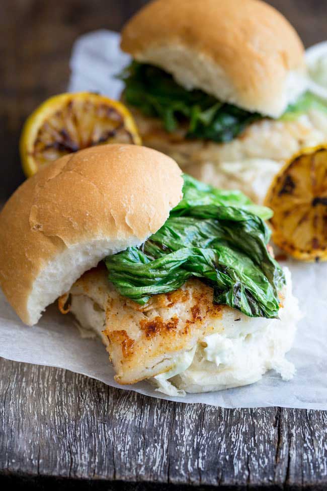 Crispy fish with a delicious tarragon mayonnaise and sweet charred lettuce, all served in a soft white bread roll. This fish burger is a flavour explosion and the perfect way to enjoy fish. And ready in under 15 minutes! From www.sprinklesandsprouts.com