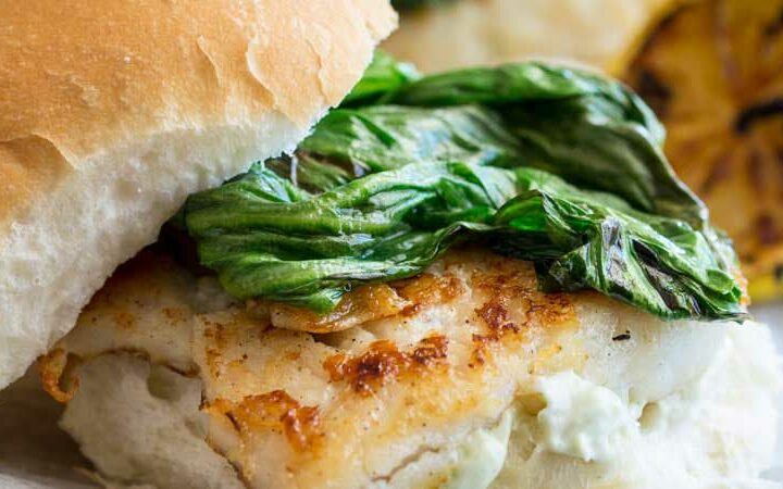 Crispy fish with a delicious tarragon mayonnaise and sweet charred lettuce, all served in a soft white bread roll. This fish burger is a flavour explosion and the perfect way to enjoy fish. And ready in under 15 minutes! From www.sprinklesandsprouts.com