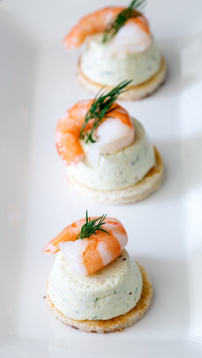 Cucumber Mousse And Dill Prawn Bites are sublime. The subtle and refreshing taste of cucumber combined in a soft heavenly mousse, sat on top of a crispy toast circle and topped with a succulent prawn and the freshness of dill.
