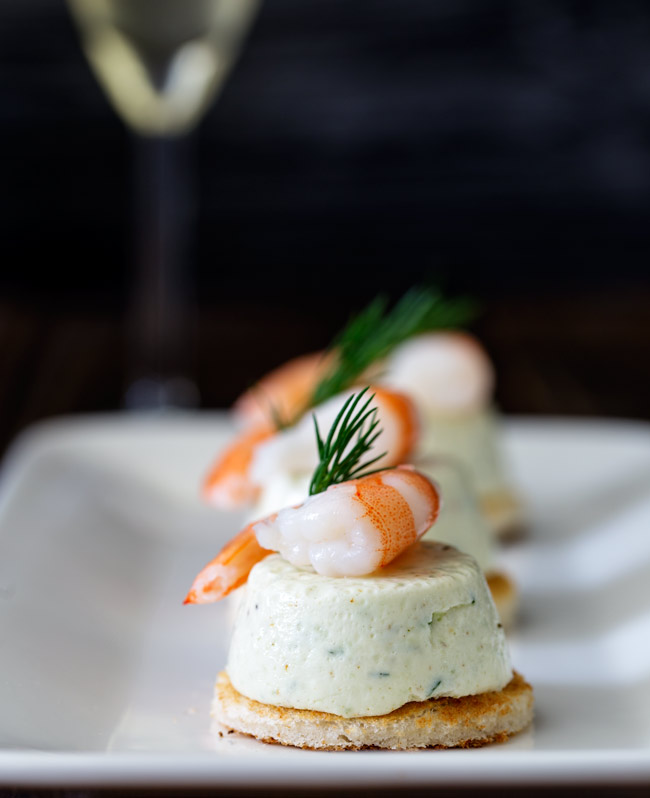 These Cucumber Mousse And Dill Shrimp Bites are sublime. The subtle and refreshing taste of cucumber combined in a soft heavenly mousse, sat on top of a crispy toast circle and topped with a succulent shrimp and the freshness of dill.