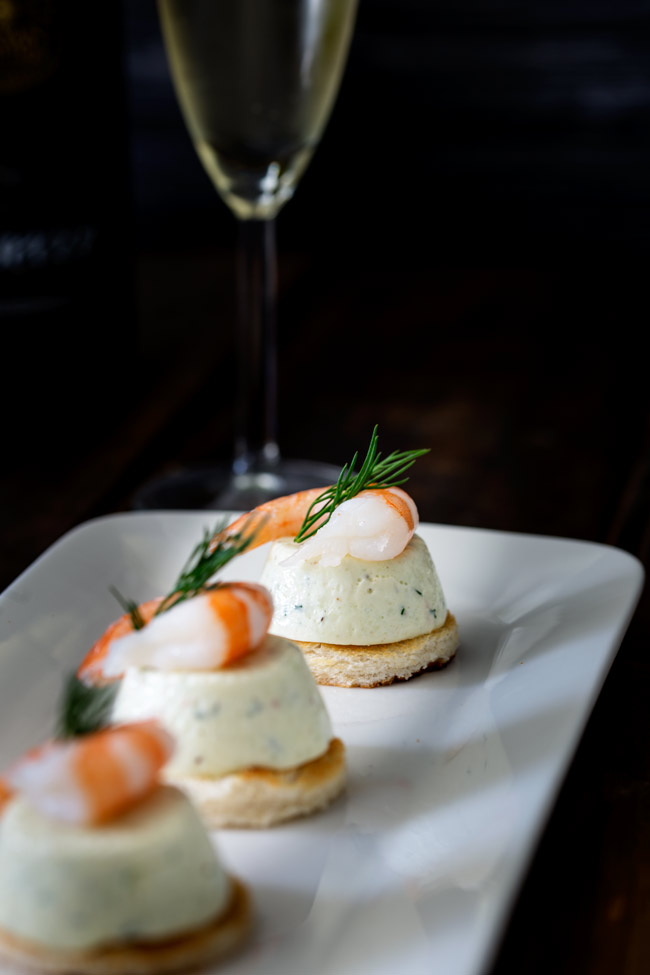 These Cucumber Mousse And Dill Shrimp Bites are sublime. The subtle and refreshing taste of cucumber combined in a soft heavenly mousse, sat on top of a crispy toast circle and topped with a succulent shrimp and the freshness of dill.