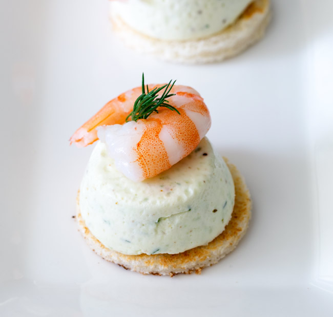 Cucumber Mousse And Dill Prawn Bites are sublime. The subtle and refreshing taste of cucumber combined in a soft heavenly mousse, sat on top of a crispy toast circle and topped with a succulent shrimp and the freshness of dill.