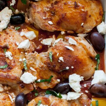 One pan Greek chicken in a rich tomato sauce packed with onion and capsicums. Baked in the oven and then topped with crumbled feta, briny olives and fresh oregano. This Greek chicken dish is perfect for feeding your family. Add some buttered couscous, maybe a green salad and some bread and you have a Greek feast!!!!