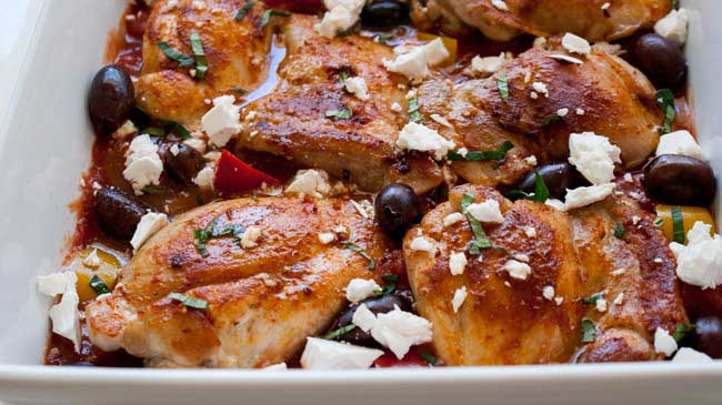One pan Greek chicken in a rich tomato sauce packed with onion and capsicums. Baked in the oven and then topped with crumbled feta, briny olives and fresh oregano. This Greek chicken dish is perfect for feeding your family. Add some buttered couscous, maybe a green salad and some bread and you have a Greek feast!!!!