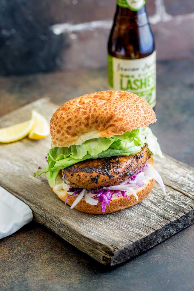 This juicy Peri Peri chicken burger is perfect for Nando lovers. The homemade marinade takes the humble chicken breast and turns it into a juicy and delicious dinner. Plus the fennel slaw!!! Oh so refreshing and perfect against the slight spicy of the burger. Recipe from Sprinkles and Sprouts | Delicious food for easy entertaining.
