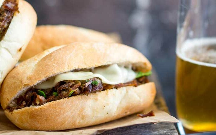 These Pressure Cooker Italian Beef Subs are the perfect midweek meal for the whole family. Juicy succulent shredded beef, stuffed inside soft rolls topped with provolone and dunked into a flavour packed gravy/sauce. Everyone who tries these loves these and they are so simple to make. Recipe includes instructions for Instant Pot and Stove top pressure cookers.