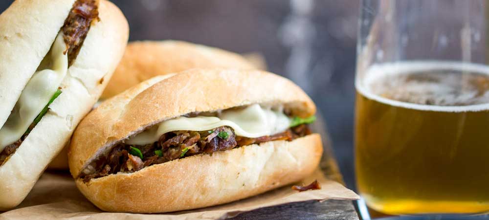 These Pressure Cooker Italian Beef Subs are the perfect midweek meal for the whole family. Juicy succulent shredded beef, stuffed inside soft rolls topped with provolone and dunked into a flavour packed gravy/sauce. Everyone who tries these loves these and they are so simple to make. Recipe includes instructions for Instant Pot and Stove top pressure cookers.