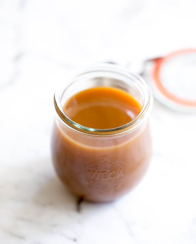 This homemade salted caramel sauce is easy to make and doesn't require a candy thermometer. It is rich, creamy, smooth and salty. Everything a salted caramel sauce should be! Recipe from Sprinkles and Sprouts | Delicious food for easy entertaining.