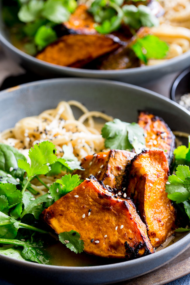 Close up on the noodle bowl, showing the wedges of pumpkin and the miso broth