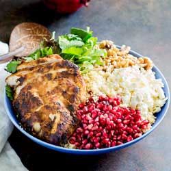 This Moroccan Chicken Couscous Buddha Bowl is there perfect lunch. The chicken is marinated in wonderful moroccan seasoning, whist the sweet tart pomegranate and salty feta round out the dish.  Served onto of a bed of couscous with plenty of fresh salad and herbs, this moroccan buddha bowl is sure to leave you feeling satisfied. Recipe from Sprinkles and Sprouts | Delicious food for easy entertaining.