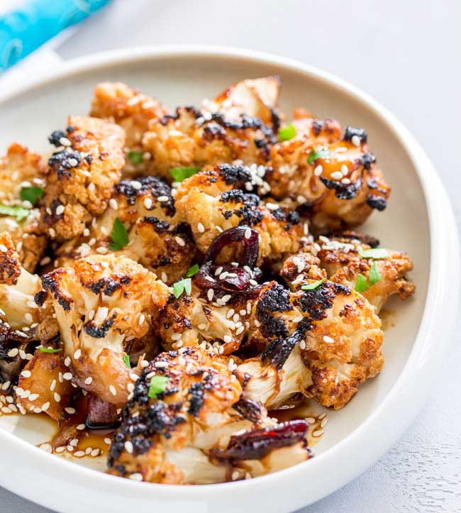 This Oven Baked Honey Soy Sesame Cauliflower is an umami rich dish, full of sticky, sweet flavours that will delight vegetarians and meat eaters alike. It is quick to prepare and then happily bakes in the oven. From Sprinkles and Sprouts