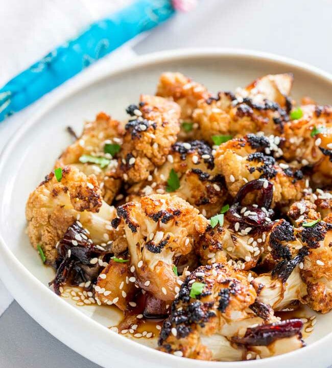 This Oven Baked Honey Soy Sesame Cauliflower is an umami rich dish, full of sticky, sweet flavours that will delight vegetarians and meat eaters alike. It is quick to prepare and then happily bakes in the oven. From Sprinkles and Sprouts