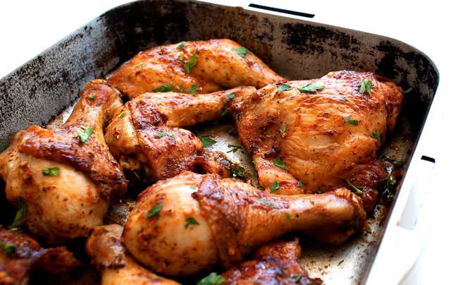a silver coating pan filled with joints of peri peri chicken