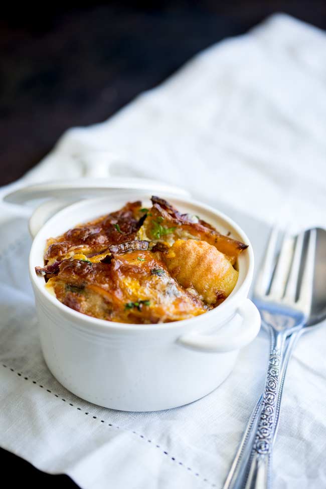 Large white ramekin with an individual serving of Baked Pumpkin Gnocchi. 