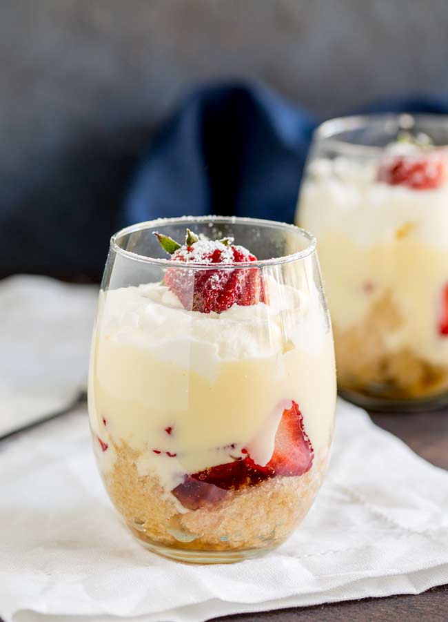 Strawberry Trifles served in stemless wine glasses.
