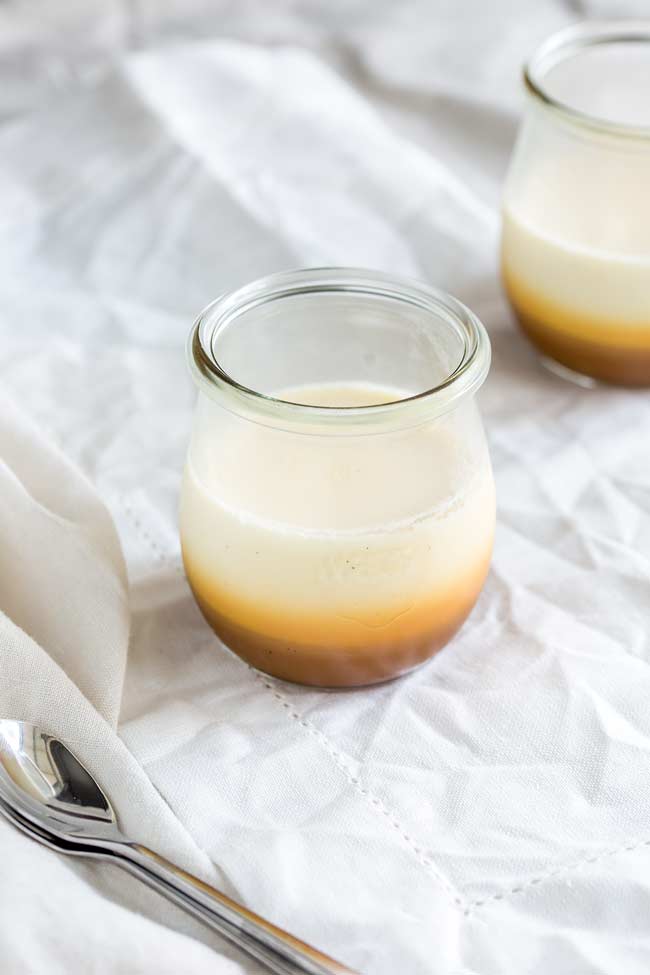 almost overhead on a glass jar, showing the creamy wobbly pan cotta texture
