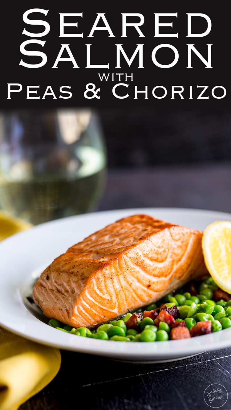 Pin. Zoomed in shot of the crispy salmon on the green peas in a white bowl with a yellow napkin and wine glass.