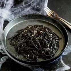 This Witches hair pasta is the perfect dinner for Halloween night. Jet black strands of squid ink pasta dressed with a garlic and chilli oil. Delicious, simple and dramatic. And there is plenty of garlic in there to keep the vampires at bay....well it is Halloween!  Recipe from Sprinkles and Sprouts | Delicious food for easy entertaining.