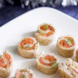 Smoked Salmon and Dill Pinwheels on a white platter.