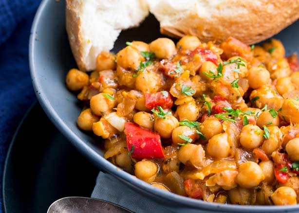 This Tomato and Chickpea Stew is low fat, gluten free and vegan. It is also packed full of fresh Italian flavors. The rich tomato, sweet onions and plenty of Italian herbs, make this stew a delicious yet simple dinner idea. Recipe by Sprinkles and Sprouts | Delicious food for easy entertaining
