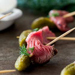 Strips of tender, sweet pickle marinated beef paired with the crunchy of a dill pickle. These Dill Pickle Beef Skewers are a delicious and easy party appetizer. Or serve them on game night as a easy to eat snack.