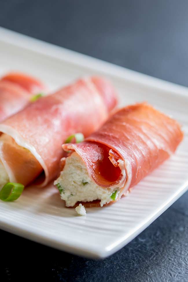 Close up on the prosciutto rolls, clearly showing the white ricotta filling