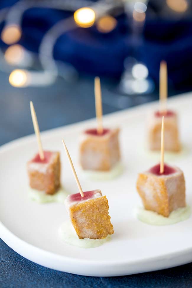 Close up on a seared tuna skewers showing the crisp golden exterior.