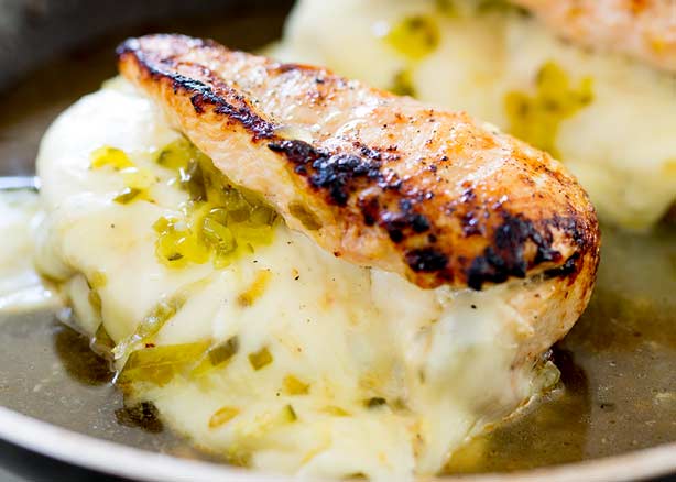 close up on the melted cheese stuffing in these dill pickles stuffed chicken breasts