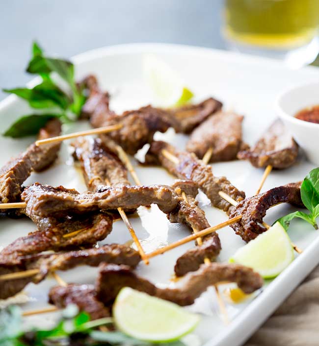 close up on the crispy edges of the grilled thai beef skewers