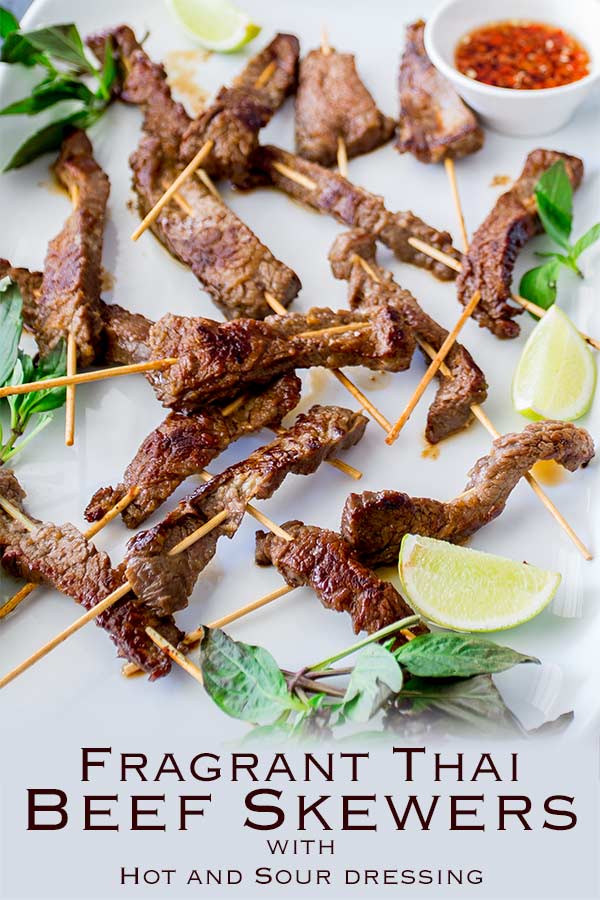 Pin image, platter covered with thai beef skewers and text at the bottom