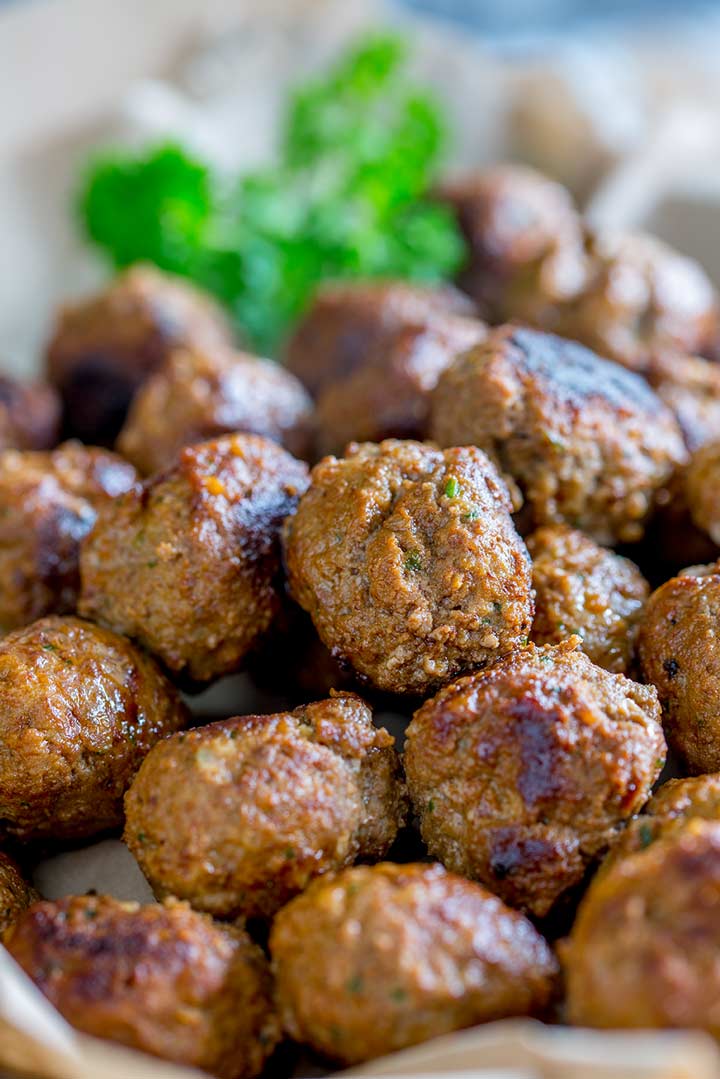 Close up on a pile of meatballs showing the light crust on the outside