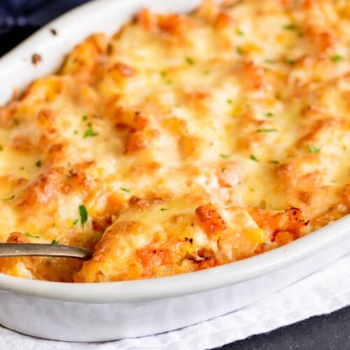 close up on a scoop being taken from this cheesy casserole