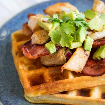 Square image showing a close up of the turkey, bacon and avocado topping on the waffles