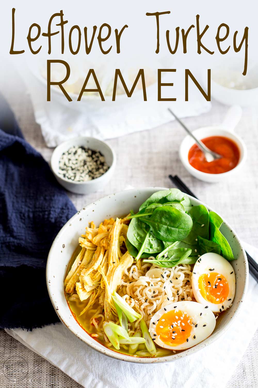 pinterest image of a table with two turkey ramen bowls with text at the top