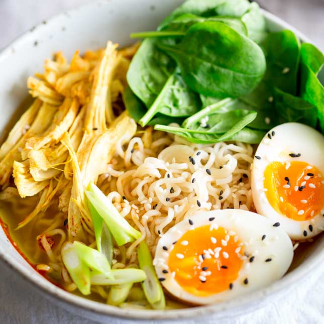 close up on the toppings of the ramen bowl, turkey, egg and spinach