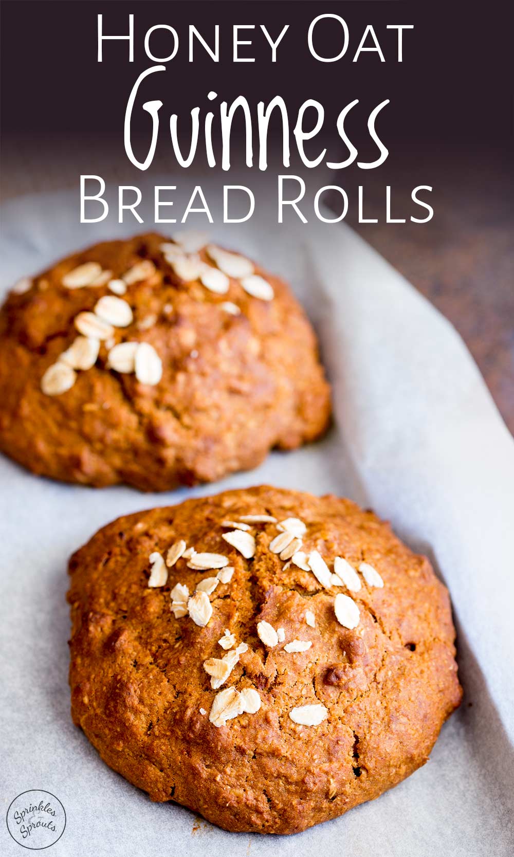 close up on two brown Guinness bread rolls sprinkled with oats