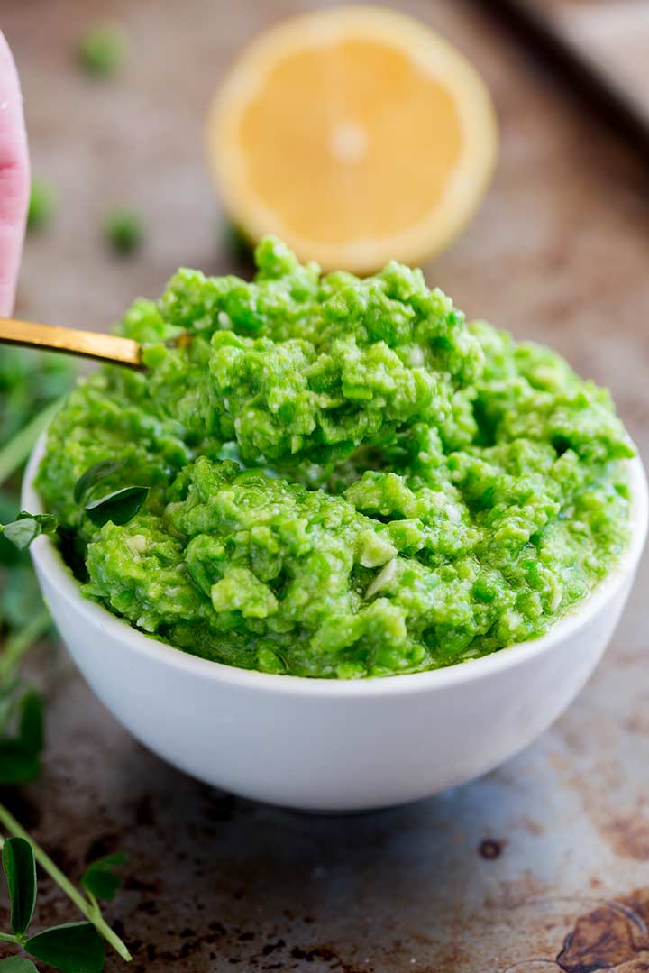 a gold spoon scooping out some pea pesto