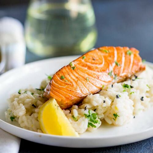 close up on the seared salmon on abed of lemon risotto