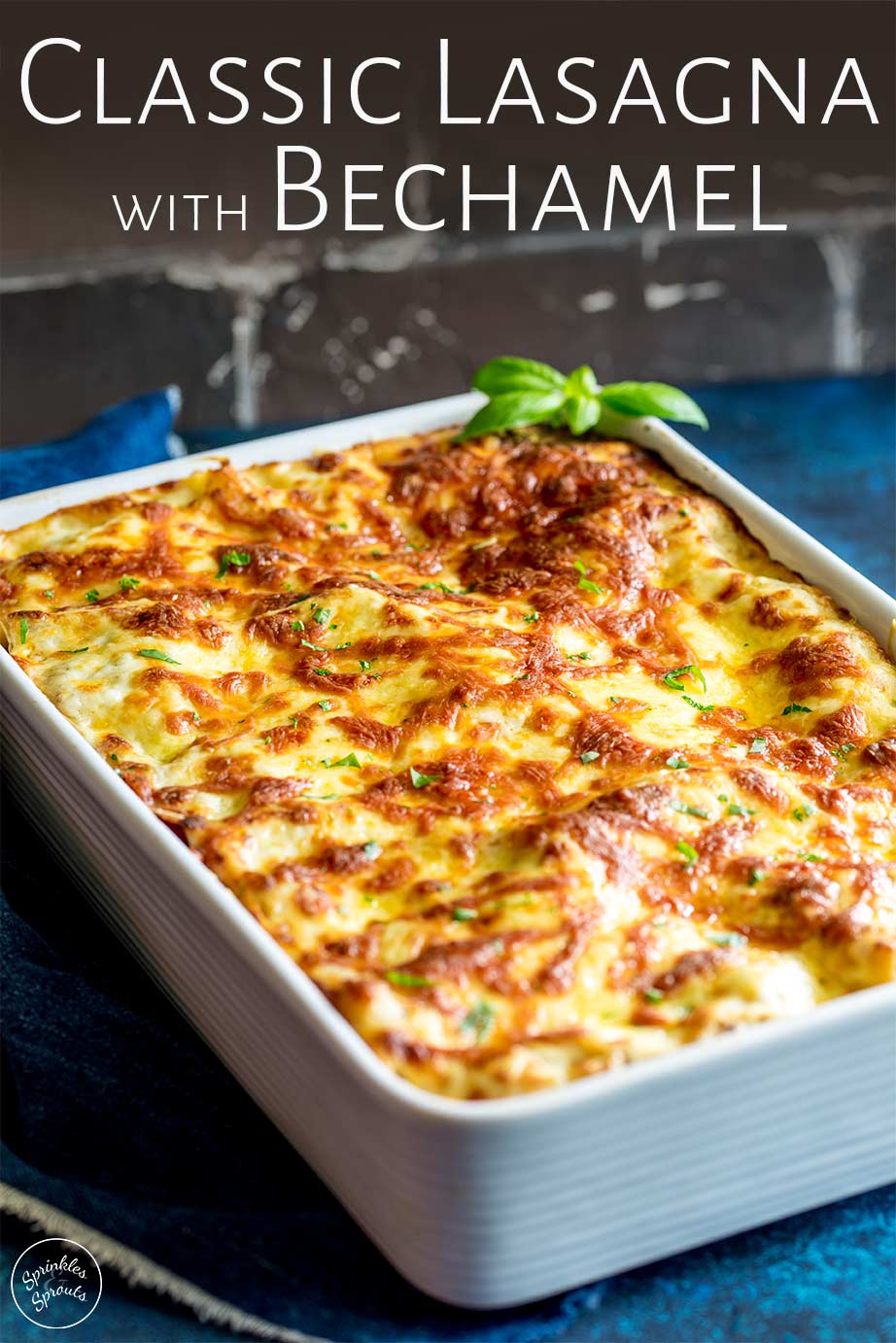large white dish of lasagna with text at the top