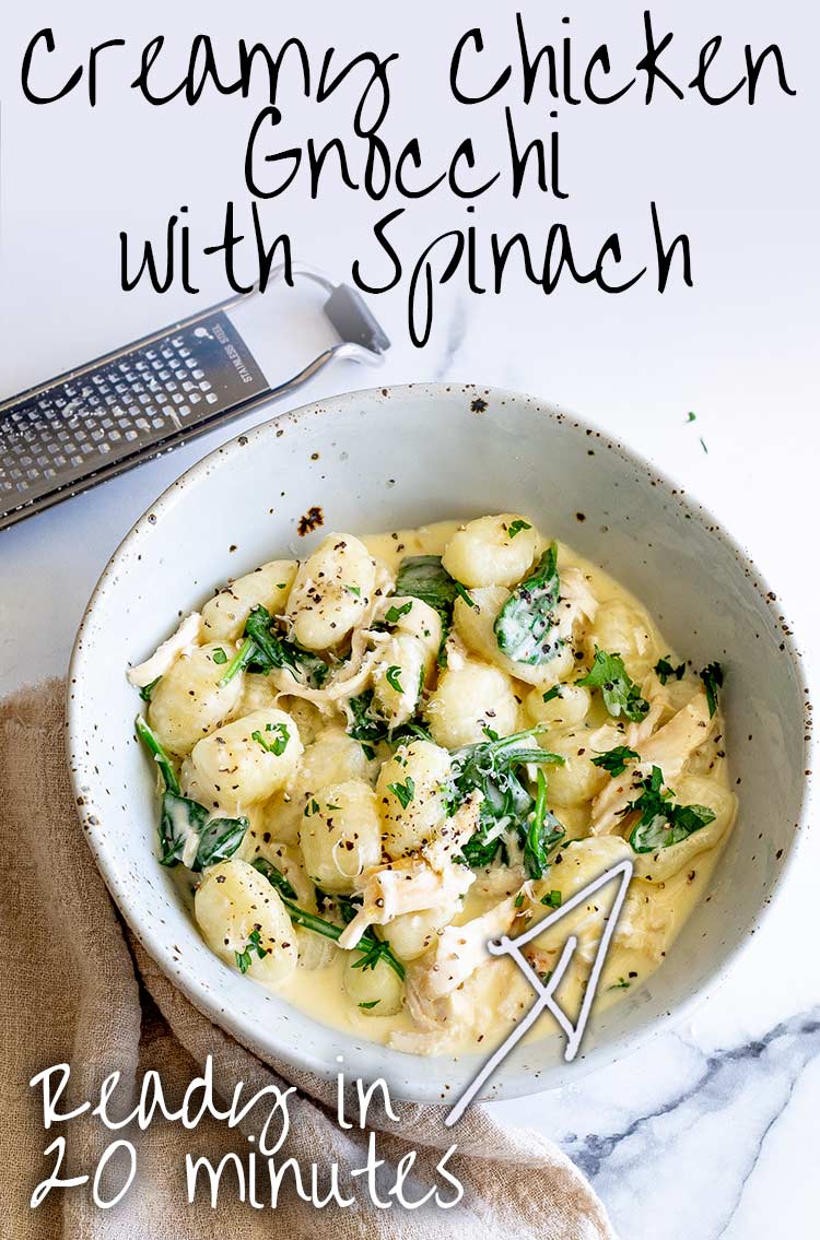 A rustic bowl filled with creamy chicken gnocchi next to a grater and linen napkin text at the top
