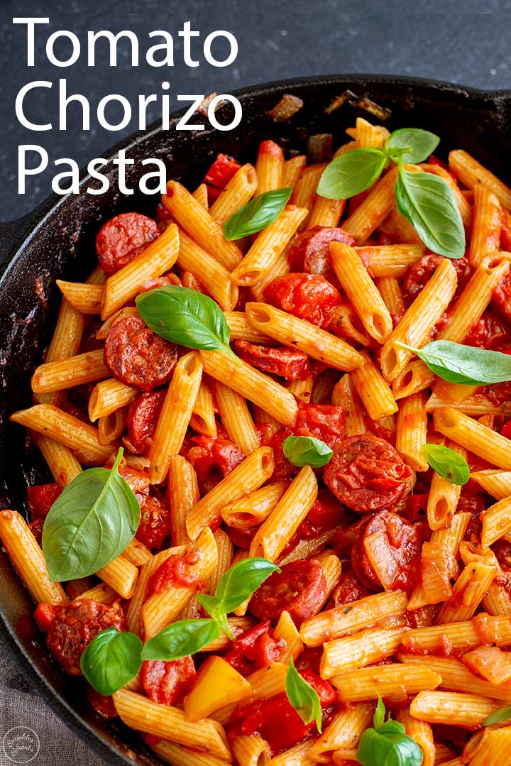 Tomato Chorizo Pasta in a cast iron skillet with text at the top