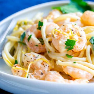 close up on a shrimp in the creamy lemon pasta