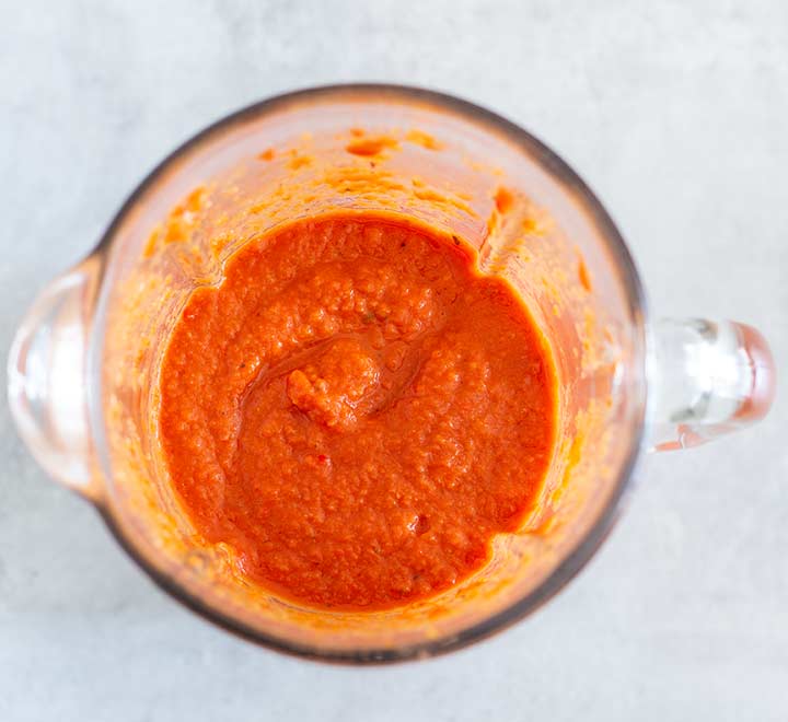 overhead shot of the red sauce for pasta in a blender.