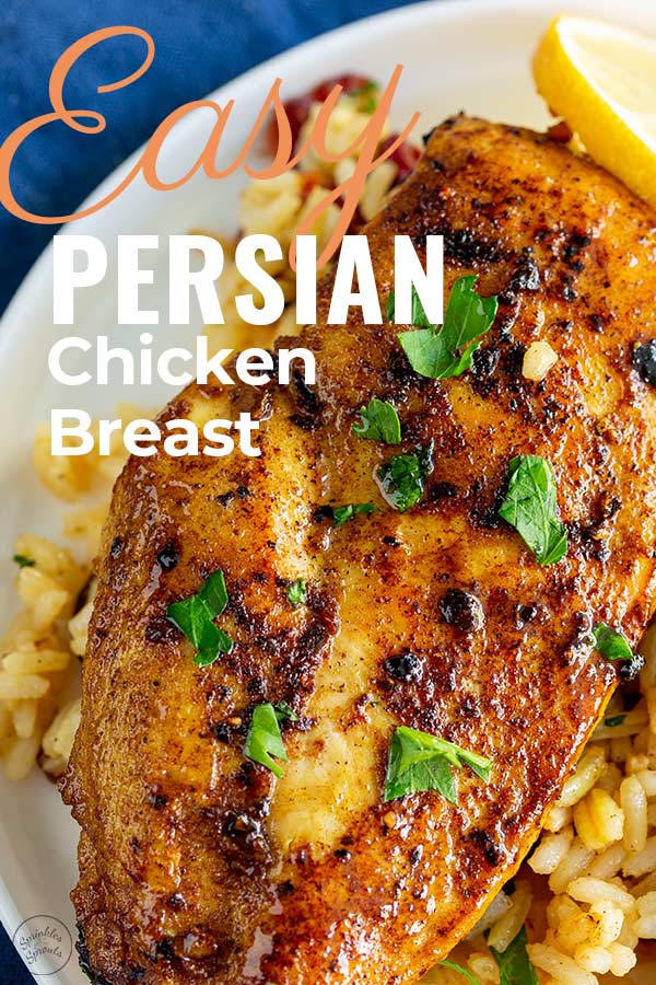 overhead view of a cooked Persian chicken breast on a bed of rice with writing in the top left