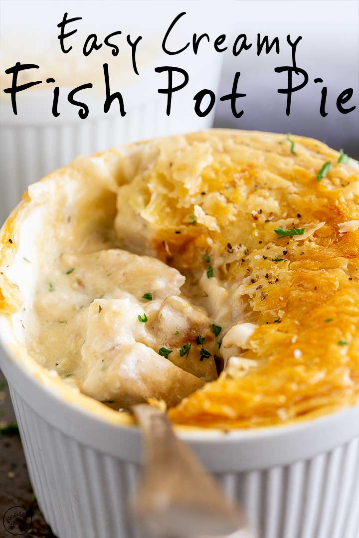 a spoon lifting up the creamy fish filling from a pot pie, with text at the top