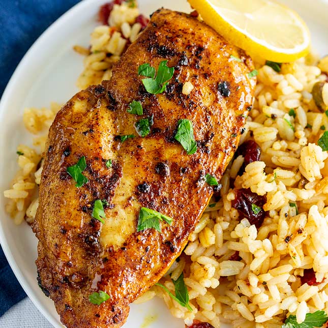 overhead shot of a golden red Persian Chicken breast on a bed of rice