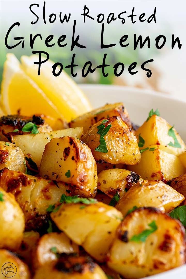 Greek potatoes win a white bowl with lemon wedges and text at the top