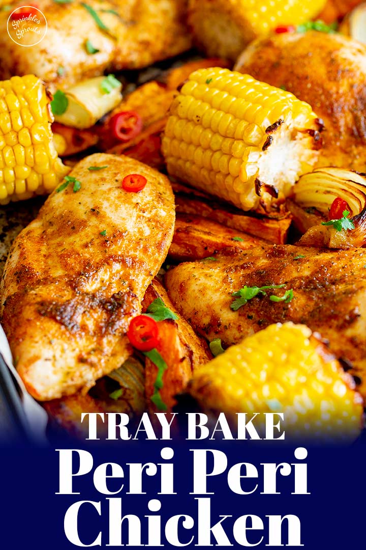 peri peri chicken on a sheet pan with veggies with text at the bottom