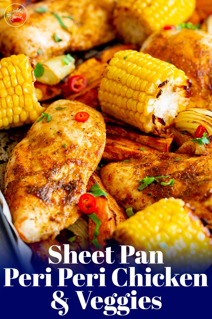 peri peri chicken on a sheet pan with corn with text at the bottom